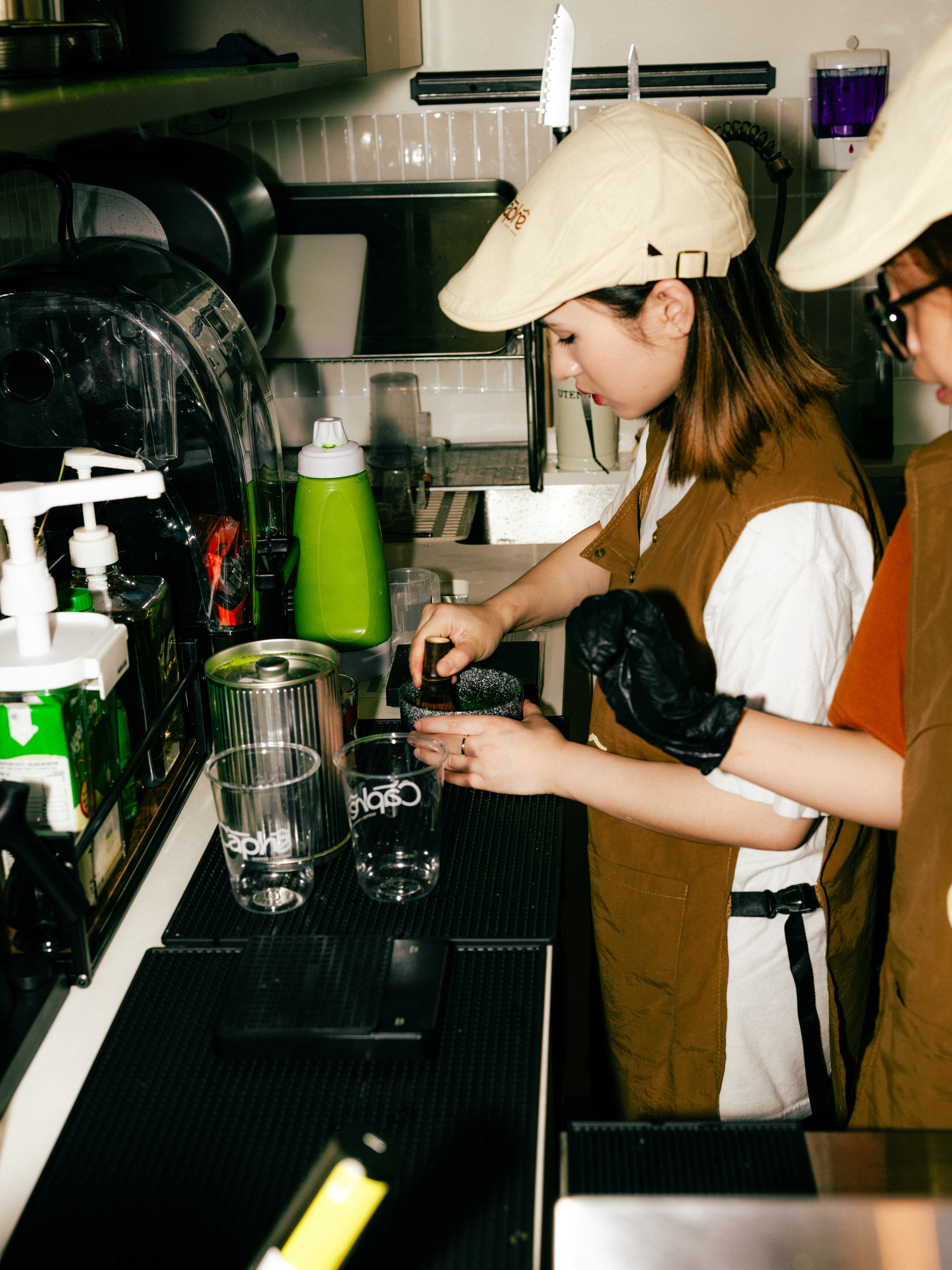 Barista hand-whisking matcha behind the counter